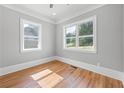 Bright bedroom with hardwood floors, two large windows, and neutral paint at 4267 Matisse Ln, Fairburn, GA 30213