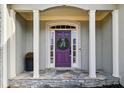 Close up of front door with stone porch and cream colored columns at 2669 Glenrose Hl, Atlanta, GA 30341