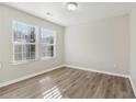 Spacious bedroom with neutral walls and wood-look floors at 6897 Estepona St, Atlanta, GA 30349