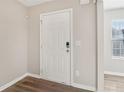 Interior entry door with neutral-colored walls and wood-look floors at 6897 Estepona St, Atlanta, GA 30349