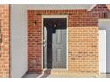 Dark-colored front door with a brick exterior at 6897 Estepona St, Atlanta, GA 30349