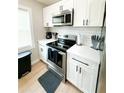 Modern kitchen with white shaker cabinets and stainless steel appliances at 1705 Nw Mary George Ave, Atlanta, GA 30318