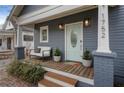 Inviting front porch with light blue door and comfy seating area at 1752 Ridgeway Nw Ave, Atlanta, GA 30318