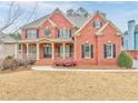 Two story home with front porch and landscaping at 6037 Addington Nw Dr, Acworth, GA 30101