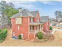 Brick home's side view, showcasing landscaping and AC units at 6037 Addington Nw Dr, Acworth, GA 30101