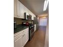 Modern kitchen with stainless steel appliances and dark countertops at 103 Live Oak Ct, Dallas, GA 30157