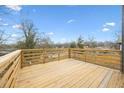Wooden deck with railing offers a view of the treeline at 550 Paines Nw Ave, Atlanta, GA 30318
