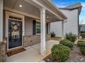 Inviting front porch with white columns and a charming door at 1087 Shadow Glen Dr, Fairburn, GA 30213