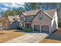 Two-story house with a two-car garage and mature trees at 11850 Markham Way, Hampton, GA 30228