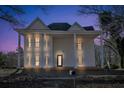 Evening view of a two story home with wrap around porch at 119 E Johnson E St, Temple, GA 30179