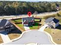 Aerial view of a house on a corner lot in a residential neighborhood at 799 Blue Juniper Cir, Loganville, GA 30052