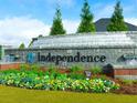 Independence community entrance with a stone water feature and landscaping at 799 Blue Juniper Cir, Loganville, GA 30052