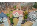 An aerial view of a home featuring a well-maintained yard and a neatly paved driveway, surrounded by lush trees at 1692 Branch Creek Cv, Lawrenceville, GA 30043