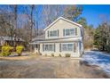 Neutral siding home featuring black shutters, front yard, and a classic architectural style at 3049 Flat Shoals Rd, Atlanta, GA 30349