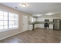 Bright kitchen with stainless steel appliances, white cabinets, and wood-look flooring at 3049 Flat Shoals Rd, Atlanta, GA 30349