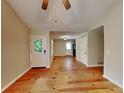 Bright living room featuring hardwood floors and access to other rooms at 4230 Pilgrim Point Rd, Cumming, GA 30041