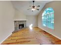 Spacious living area with hardwood floors and a stone fireplace at 4230 Pilgrim Point Rd, Cumming, GA 30041