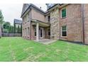 Spacious backyard with brick patio and lush green lawn at 7890 Royal Melbourne Way, Duluth, GA 30097