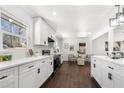 White kitchen with stainless steel appliances and hardwood floors at 2277 Cloverdale Se Dr, Atlanta, GA 30316