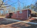 Side view of brick ranch house showcasing carport at 6242 Prestley Mill Rd, Douglasville, GA 30134