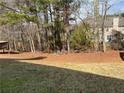 A spacious backyard with natural landscaping, providing a private and serene outdoor space at 7981 Gossamer Dr, Fairburn, GA 30213