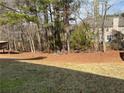 Serene backyard with lush greenery and mature trees, offering a private retreat at 7981 Gossamer Dr, Fairburn, GA 30213