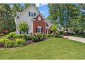 Two-story home with lush landscaping and a long driveway at 1479 Brentwood Dr, Marietta, GA 30062