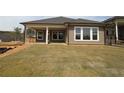 New sod lawn in backyard with covered patio and view of treeline at 2012 Ripple Park Bnd, Canton, GA 30114