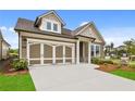 Lovely home showcasing a two-car garage, manicured lawn and complemented by beautiful landscaping at 2012 Ripple Park Bnd, Canton, GA 30114