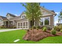 Beautifully landscaped front yard, inviting curb appeal, with a well-maintained lawn at 2012 Ripple Park Bnd, Canton, GA 30114