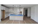 Bright kitchen with white cabinets, large island, and modern pendant lighting at 2012 Ripple Park Bnd, Canton, GA 30114