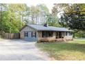 Brick ranch house with attached garage and a spacious yard at 1167 Mcclung Rd, Hiram, GA 30141