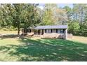 Ranch house with a large front yard and mature trees at 1167 Mcclung Rd, Hiram, GA 30141