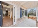 View of the front porch with wood-look floors and blue shutters at 1421 Stephens View Dr, Loganville, GA 30052