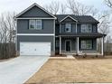 Two-story home with a two-car garage, dark gray siding, and a well-manicured front yard at 5547 Bent Grass Way, Douglasville, GA 30135