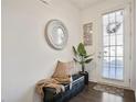 Bright entryway with bench, mirror, and hardwood floors at 7711 Cabrini Pl, Fairburn, GA 30213