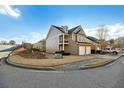 Side view of the house showcasing landscaping and driveway at 5105 Deepwater Cv, Acworth, GA 30101