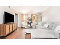 Spacious living room with hardwood floors, sectional sofa, and large TV at 12 Independence Nw Pl # 12, Atlanta, GA 30318