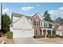 Two-story house with a two car garage and landscaping at 3648 Ramsey Close Sw, Atlanta, GA 30331