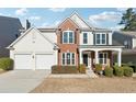 Two-story home with brick and siding, a two-car garage and landscaping at 3648 Ramsey Close Sw, Atlanta, GA 30331