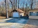 Detached garage with large door in wooded setting at 4350 Rockdale Dr, Acworth, GA 30101