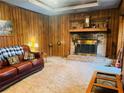 Living room features a brick fireplace and wood paneling at 4350 Rockdale Dr, Acworth, GA 30101