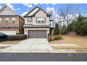 Two-story home with attached garage and driveway at 8775 Village Pl, Suwanee, GA 30024