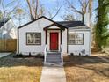 Newly renovated white house with red door, steps and walkway at 942 Lawton Sw St, Atlanta, GA 30310