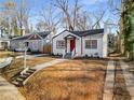 Newly renovated white house with red door, steps and walkway at 942 Lawton Sw St, Atlanta, GA 30310