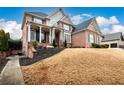 Brick home with a walkway and landscaping at 2057 Chambord Way, Snellville, GA 30078