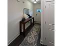 Bright hallway with stylish console table and rug at 1887 Plainsboro Dr, Lithonia, GA 30058