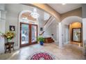 Two-story foyer with tile flooring, chandelier, and curved staircase at 5041 Towne Lake N Hls, Woodstock, GA 30189