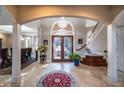 Two-story foyer with tile flooring, chandelier, and curved staircase at 5041 Towne Lake N Hls, Woodstock, GA 30189