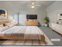 Virtually staged main bedroom with a large bed, dresser, and carpet flooring at 1206 Persimmon Way, Mcdonough, GA 30252